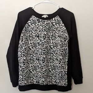 Black sweater with white roses.